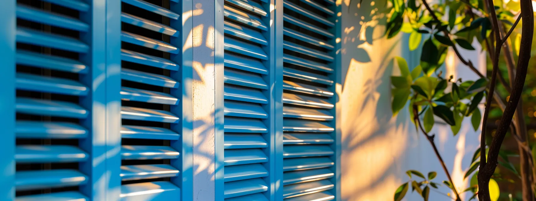 vivid blue rolling shutters on a sunny los angeles home, enhancing energy efficiency and protecting against extreme weather.